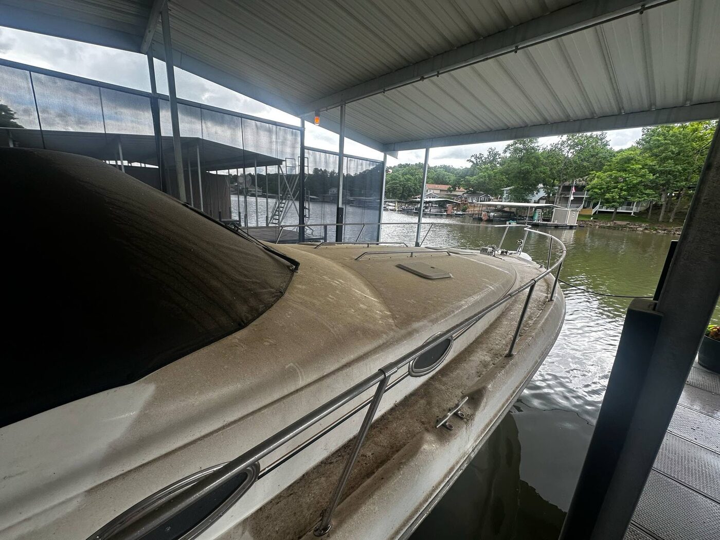 Boat bow with heavily oxidized, stained gelcoat before detailing