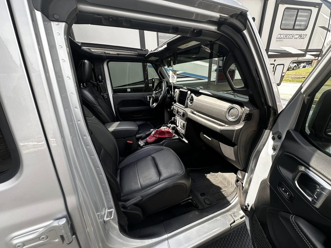 Freshly detailed Jeep Wrangler interior with clean black leather seats and dash